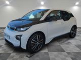 the bmw i3 is parked on a checkered tile floor