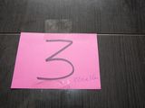 a pink piece of paper with the number 3 on it