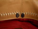 a close up view of a purse with two buttons on it