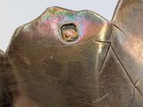 a close up of a metal object with a hole in it
