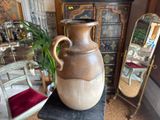 a large vase that is sitting on a table in a room