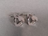 pair of silver plated cufflinks with a horse head on them