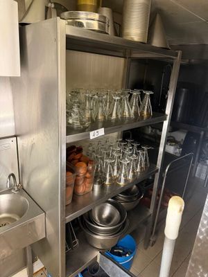 many glasses on the shelves in the kitchen