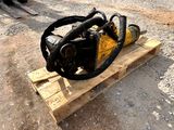 a chainsaw sitting on a pallet on the ground