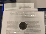 a close up of a piece of paper with a coin on it