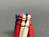 three wooden figurines that are standing together