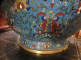 a large blue bowl with a gold base on a table