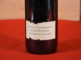a bottle of wine sitting on a table with a red cloth