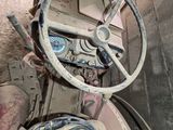 a steering wheel and dash board of an old truck