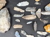 several pieces of rock and stone are arranged in a circle on a black surface