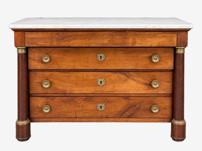 an antique chest of drawers with marble top