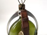 a green glass bottle with a tag on it