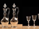 many wine glasses lined up in a row on a table