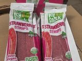 two bags of strawberries sit on top of a cardboard box