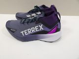 purple and black tennis shoes with the word terrex on them