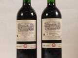 deux bouteilles de vin rouge posées l'une à côté de l'autre sur une table