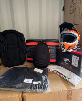a box with a helmet, gloves, and other items on it