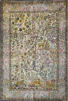 an antique persian rug with a tree of life in the center