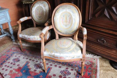 two chairs that are sitting on a rug in a room