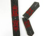 une paire de cravates noires et rouges ornées de lettres rouges