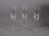 three wine glasses sitting next to each other on a table