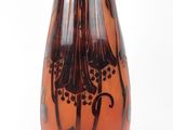 a glass vase with a design on it on a stand
