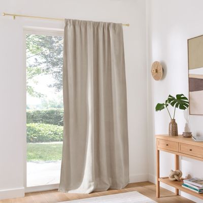 curtains in a living room with a white rug and a wooden table