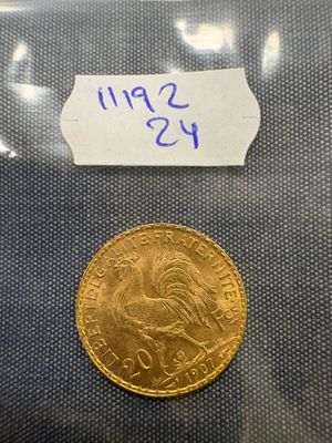 a gold coin with a label on it sitting on top of a table