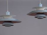 two light fixtures hanging from the ceiling of a room