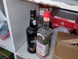 a shelf with bottles of liquor on it in a kitchen