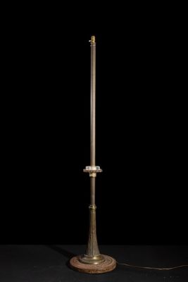 an old fashioned lamp on a black surface with a black background