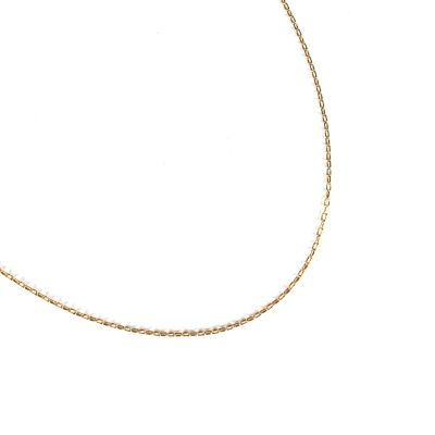 a close up of a gold chain necklace on a white background
