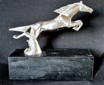 statue of a horse jumping on a marble base on a black background