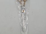 a pair of scissors in a plastic bag on a table