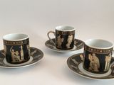 three coffee cups and saucers are sitting on a white surface