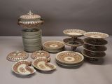 many plates and bowls sitting on a table