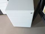 two white filing cabinets sitting next to each other in a room