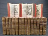 several old books are stacked on top of each other on a table