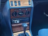 a car dashboard with a wooden dash board and blue seats