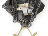 an image of a black scarf with chains hanging from it ' s neck