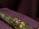 a picture of a green pipe sitting on top of a purple cloth
