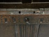 an old wooden trunk with a bunch of metal handles