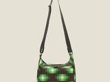 a green and black bag with a flower pattern on it