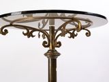 a table with a glass top and a metal base