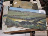 a lot of paintings that are on a table