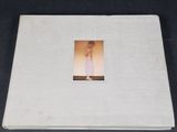 a white album with a picture of a woman in a white dress