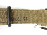 an old belt with a metal buckle on a white surface