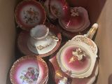 a box full of tea cups and saucers in it