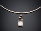 a white gold necklace with a diamond pendant on a black background
