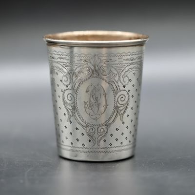 a close up of a silver cup sitting on a table